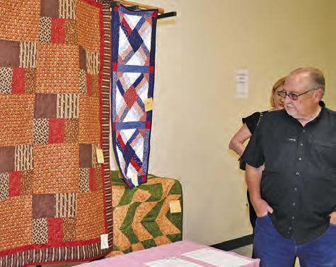 THESE QUILTS ARE admired by passersby at the New Tabor Brethren Church fundraiser on Saturday at the Expo Center in Caldwell.