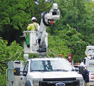 ENTERGY CREWS worked to restore power to Burleson County residents after last Thursday’s storm knocked down power lines.