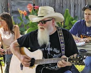 BILLY GAGE performs at the Song Circle outside Front Street Burgers in downtown Chriesman. The gatherings are enjoyed by area musicians and visitors.
